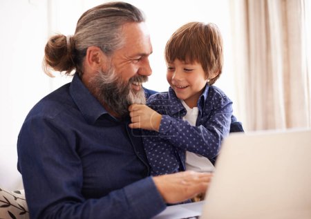 Photo for Smile, boy child and grandfather with beard and laptop, bonding and relax in living room. Happy family, play and fun with grandpa and pulling face hair, elearning and online with computer for learn. - Royalty Free Image