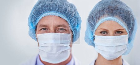 Photo for Face mask, doctors and portrait with surgery and safety gear for healthcare and wellness job. Hospital, ppe and people in clinic with working and health protocol in facility with care and staff. - Royalty Free Image
