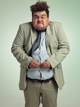 Photo for Overweight, portrait and man fitting in shirt, studio and employee with stomach for clothes. Plus size, male person and guy with obesity unhappy with fat of belly in suit for professional job. - Royalty Free Image