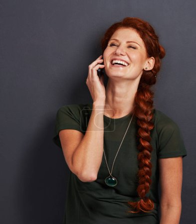 Photo for Smile, phone call and woman in studio with online chat, networking and happy connection. Communication, internet and girl with smartphone, laughing and and talking on mobile app with dark background. - Royalty Free Image