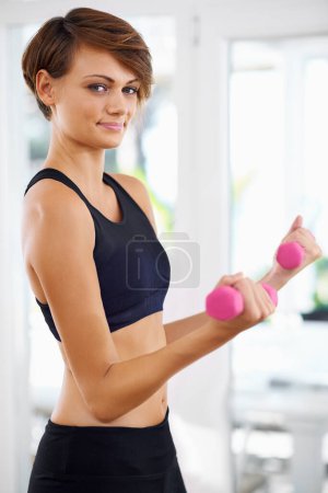 Photo for Home workout, portrait or woman with fitness, dumbbells or power for strength training, gym studio or exercise. Athlete, sports or body of female person with weights, energy or strong arms for health. - Royalty Free Image