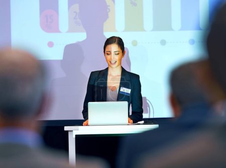 Business woman, podium and presentation with projector screen, conference or workshop with laptop for slideshow. Corporate training, seminar and speaker with info, audience and professional speech.