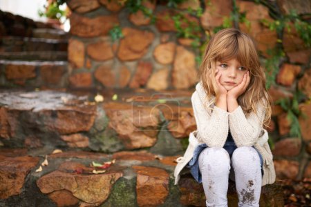 Photo for Thinking, sad and girl child in a garden bored, waiting or disappointed, unhappy or moody outside. Children, problem and frustrated kid in a park lonely, moody or upset outdoor with angry or tantrum. - Royalty Free Image