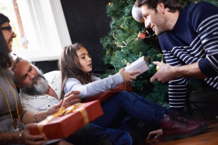Photo for Father, child and gift by Christmas tree in home, festive season and present for bonding on xmas. Happy family, girl and happy for package on religious holiday, celebration and love for tradition. - Royalty Free Image
