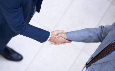 Photo for Top view, business people and handshake for deal, collaboration and b2b partnership agreement for consultant. Above, introduction and shaking hands for greeting, welcome and thank you in workplace. - Royalty Free Image