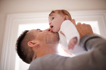 Photo for Kiss, love or father and baby in a house with care, trust and child development, support or bonding. Family, security and dad hug kid at home for learning, safety or morning games with gratitude. - Royalty Free Image