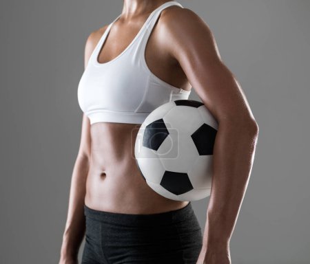 Photo for Woman, closeup and soccer player with ball for match, game or fitness on a gray studio background. Body of female person or athlete with football for sports exercise, workout or training on mockup. - Royalty Free Image