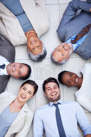 Photo for Floor, circle and portrait of business people with smile for team building, collaboration and support. Professional employees, diversity and happy with trust, solidarity and partnership from above. - Royalty Free Image