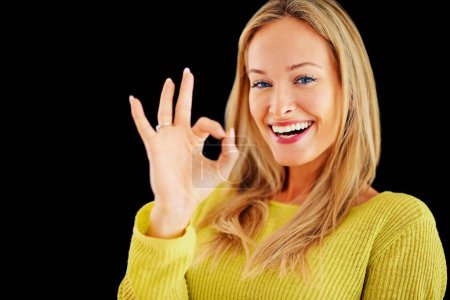 Photo for Portrait, perfect or happy woman in studio for beauty or skin approval isolated on black background. Sign, winner or confident person with okay hand gesture or emoji for agreement, like or thank you. - Royalty Free Image