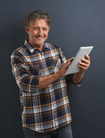 Photo for Reading, tablet and portrait of mature man in studio and learning about technology on dark background. Information, tech and mockup with post online to social media or person search internet for news. - Royalty Free Image