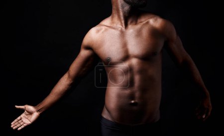 Photo for Black man, fitness and muscle with shadow for exercise or workout on a dark studio background. Closeup of young African male person or bodybuilder with masculine or muscular figure on mockup space. - Royalty Free Image