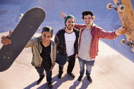 Skateboard, portrait and friends at a city park for training, fun or bonding session from above. Happy, face or top view of gen z skater men outdoor for travel, vacation or weekend reunion with hobby.