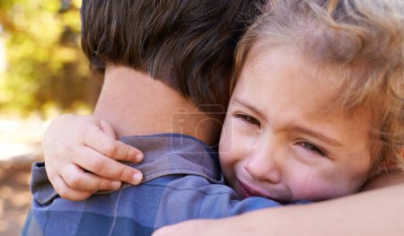 Photo for Hug, sad girl and father in a park, emotions and expression with reaction and crying with single parent. Loss, family and outdoor with dad and daughter with embrace and grief with tears, adhd or pain. - Royalty Free Image
