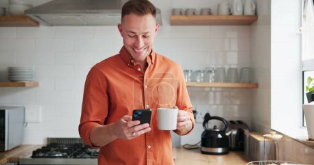 Photo for Man, drinking coffee and typing on phone or browsing social media at home, happy and relax on weekend. Male person, communication and mobile app for online conversation, humor and laughing in kitchen. - Royalty Free Image