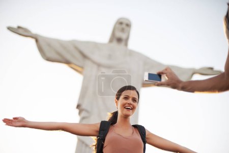 Photo for Woman, photo and jesus statue for travel, backpacking and happy on journey on summer vacation. Art deco sculpture, peace or christ the redeemer in photography of lady or tourism destination in brazil. - Royalty Free Image