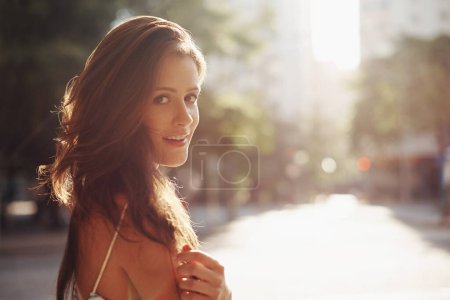 Photo for Portrait, smile and woman with sunshine, city and happiness with weekend break and travelling. Face, person and New York with girl and summer with journey and adventure with lens flare and confidence. - Royalty Free Image