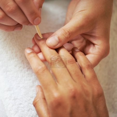 Manicure, nail care and treatment at salon, spa and technician for relaxation. Close up, woman hands or wellness for finger bed maintenance, cosmetic and beautician or manicurists with cuticle pusher.
