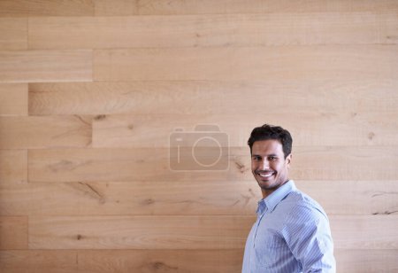 Photo for Businessman, portrait and professional by wood background and happy with commitment in career. Designer, indian and smile face for creative in job, ambition and pride in fashion shirt in office job. - Royalty Free Image