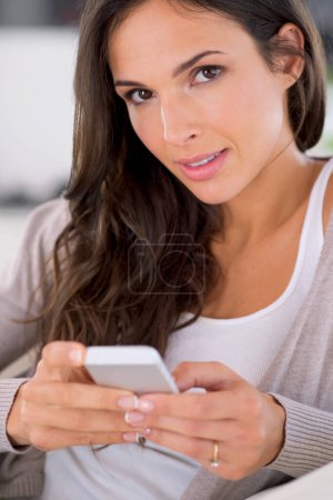 Photo for Woman, phone and texting on sofa in portrait for communication, web chat or notification in living room. Girl, person and smartphone with mobile application, typing or scroll in home on social media. - Royalty Free Image