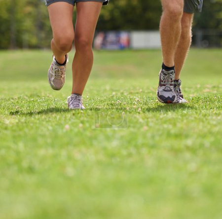 Photo for People, running shoes and closeup on grass for workout together in summer for health, wellness or training. Person, runner and partner with feet on field for exercise, fitness and speed with sneakers. - Royalty Free Image
