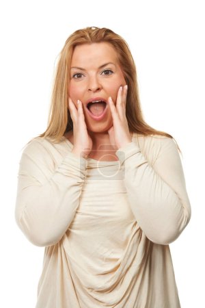 Photo for Portrait, mature woman with surprise or shock in studio, reaction and expression for news or announcement. Winner with open mouth, OMG and hands on face for success or achievement on white background. - Royalty Free Image