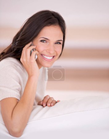 Photo for Woman, happy and portrait with phone on sofa with contact, conversation and relax in living room. Girl, person and smile with smartphone, mobile network and chat on lounge couch at house in Istanbul. - Royalty Free Image