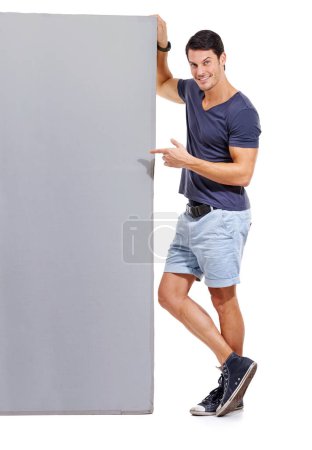 Photo for Man, pointing at mockup space and advertising signage, portrait with announcement or news on white background. Billboard, poster and sign with information, communication and about us promotion. - Royalty Free Image