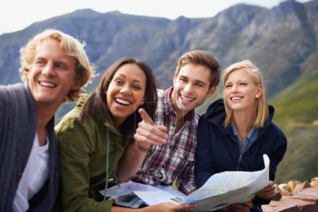 Photo for Happy people, friends and pointing with map for travel, location or destination on mountain in nature. Young group with smile, document or geographic paper for navigation, help or outdoor tourism. - Royalty Free Image