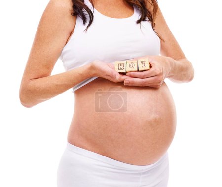 Woman, pregnancy and wood blocks in studio for gender reveal, announcement and news of future son. Mother, belly and childcare with abdomen for growth, maternity and support on white background.