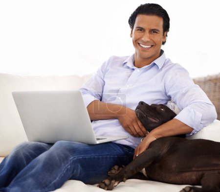 Man, dog and portrait with laptop on sofa for bonding, playing or happiness with remote work in home. Animal, person and face with smile on couch in living room for research, cuddle or love for puppy.