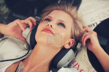 Photo for Vinyl, music and woman with headphones on floor for streaming subscription, audio and radio. Podcast, happy and above of person listening to playlist, song and track for relaxing in home with records. - Royalty Free Image