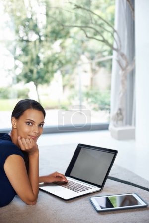 Photo for Computer, smile and portrait of woman relaxing on carpet working on freelance project at home. Happy, technology and female person with laptop for creative research laying on floor mat in living room. - Royalty Free Image
