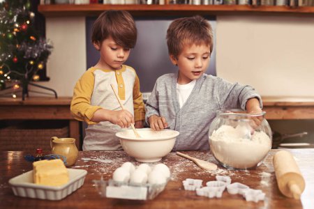 Photo for Kids, baking and playing in kitchen with flour, home and bonding with ingredients for dessert cake. Children, mixing and bowl for cookies on counter, eggs and boys learning of pastry recipe by butter. - Royalty Free Image
