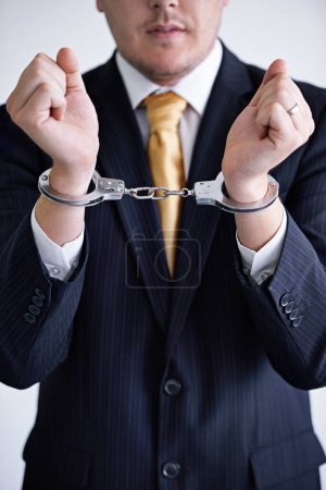 Photo for Hands, business man and handcuffs for fraud or bribery, suspicious professional deal with justice or jail. Crime, corruption or money laundering, shackles for prison with thief or criminal in finance. - Royalty Free Image