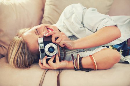 Photo for Woman, camera and couch for retro, photography and fashion in casual outfit for hobby at home. Analog, lens or female photographer in trendy, creative and clothes for relax, shoot and freelance. - Royalty Free Image