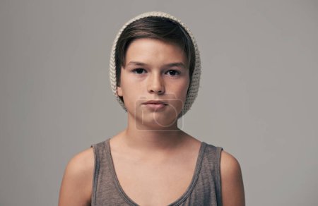 Photo for Boy, beanie and fashion in studio for portrait with teenager, edgy and aesthetic by background. Kid, model and hat with trendy style, face and pride for clothes with confidence for punk outfit. - Royalty Free Image