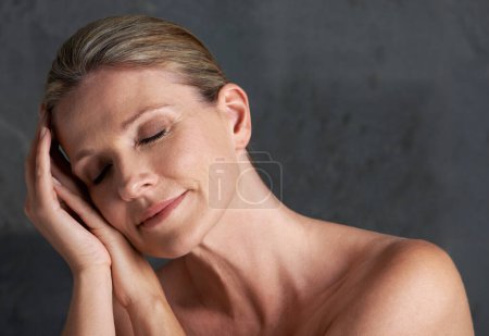 Photo for Mature woman, studio and nude for beauty, skin care and natural look in self love moment of thought. Old caucasian female person, face and dreaming in grey background, body and naked confidence. - Royalty Free Image