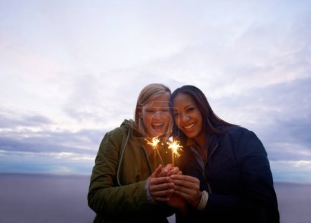 Photo for Women, friends and portrait with sparklers outdoor, celebration and fun with hiking or travel in nature. Friendship, bonding and sparks with horizon, happy for adventure together and evening sky. - Royalty Free Image