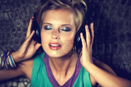 Photo for Relax, listening to music and woman with headphones, streaming radio on wall background. Person, dj and girl with headset, hip hop and entertainment with song and audio track with sound and podcast. - Royalty Free Image