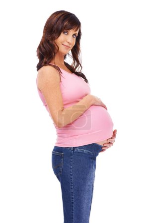 Photo for Portrait, woman and pregnant in studio smile, face and touching belly with happiness. Female person, maternity and relax on white background with casual outfit, trendy and stylish for fashion. - Royalty Free Image
