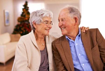 Photo for Christmas, hug and old couple with love, smile and romance with marriage and festive season. Home, Xmas tree and embrace with elderly woman, senior man and relationship with retirement or celebration. - Royalty Free Image