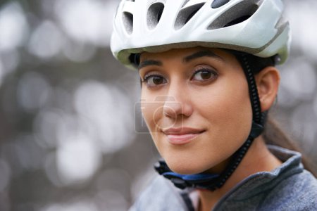 Photo for Portrait, cycling and helmet with sports woman closeup on blurred background in nature for fitness. Face, exercise and safety with happy young sports athlete or cyclist in countryside for training. - Royalty Free Image