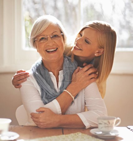 Photo for Grandmother, grandchild and happiness for bonding in portrait at nursing home with tea and conversation with love. Grandma, woman and together with affection or care, family and embrace with hug. - Royalty Free Image