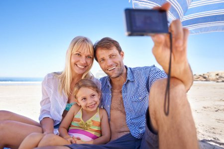 Photo for Happy family, beach and relax with selfie for photo, moment or photography in outdoor nature. Mother, father and child with smile for picture, capture or bonding memory together on the ocean coast. - Royalty Free Image
