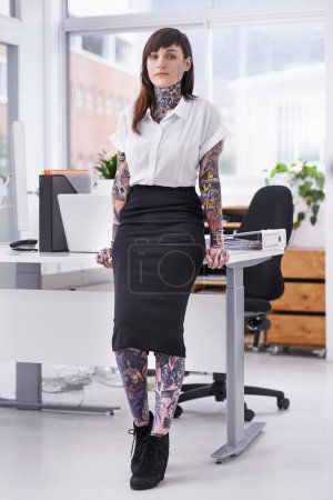 Photo for Tattoos, portrait and business woman in office with positive, good and confident attitude. Grunge, pride and professional edgy female creative designer with ink skin standing in modern workplace - Royalty Free Image