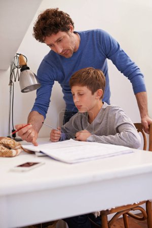 Photo for Teen, dad and help with studying in home, student and support for assignment or project. Daddy, boy and schoolwork on weekend in bedroom, education and assistance or guidance for learning by desk. - Royalty Free Image
