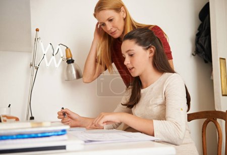 Photo for Teen, mom and help with studying in home, student and support for assignment or project. Mother, girl and schoolwork on weekend in bedroom, education and assistance or guidance for learning by desk. - Royalty Free Image