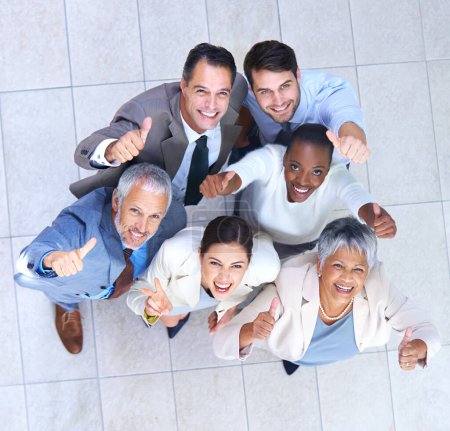 Photo for Portrait, business people and thumbs up for good job, teamwork or collaboration together in office. Top view, emoji and diversity group of employee workers for approval, agreement or yes hand gesture. - Royalty Free Image