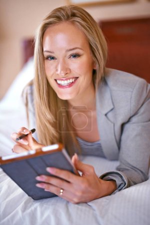 Photo for Hotel, business and portrait of happy woman on tablet for website, social media and networking on bed. Online, remote work and person on digital tech for contact, research and internet on work trip. - Royalty Free Image