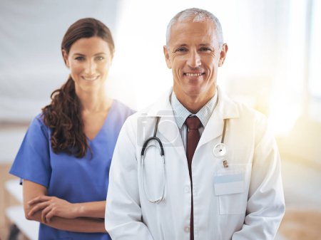 Photo for Doctors, man and woman in portrait at hospital for medical support, wellness and arms crossed with smile. Medic, surgeon and nurse in team, happy and health services in clinic with pride for career. - Royalty Free Image